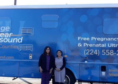 Our Elgin team standing in front of their mobile medical unit.