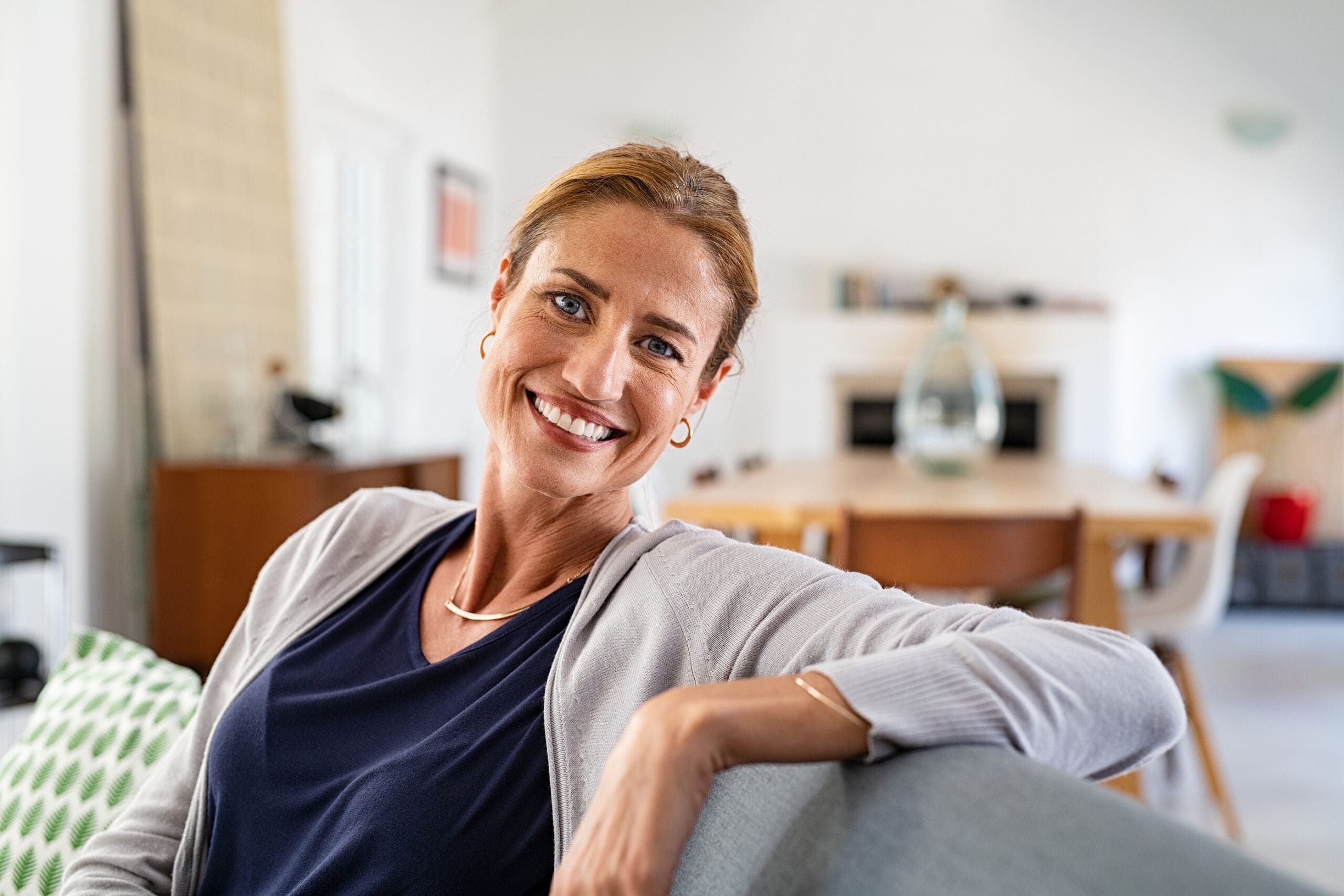 Happy mature woman after reading about parenting at Image Clear Ultrasound
