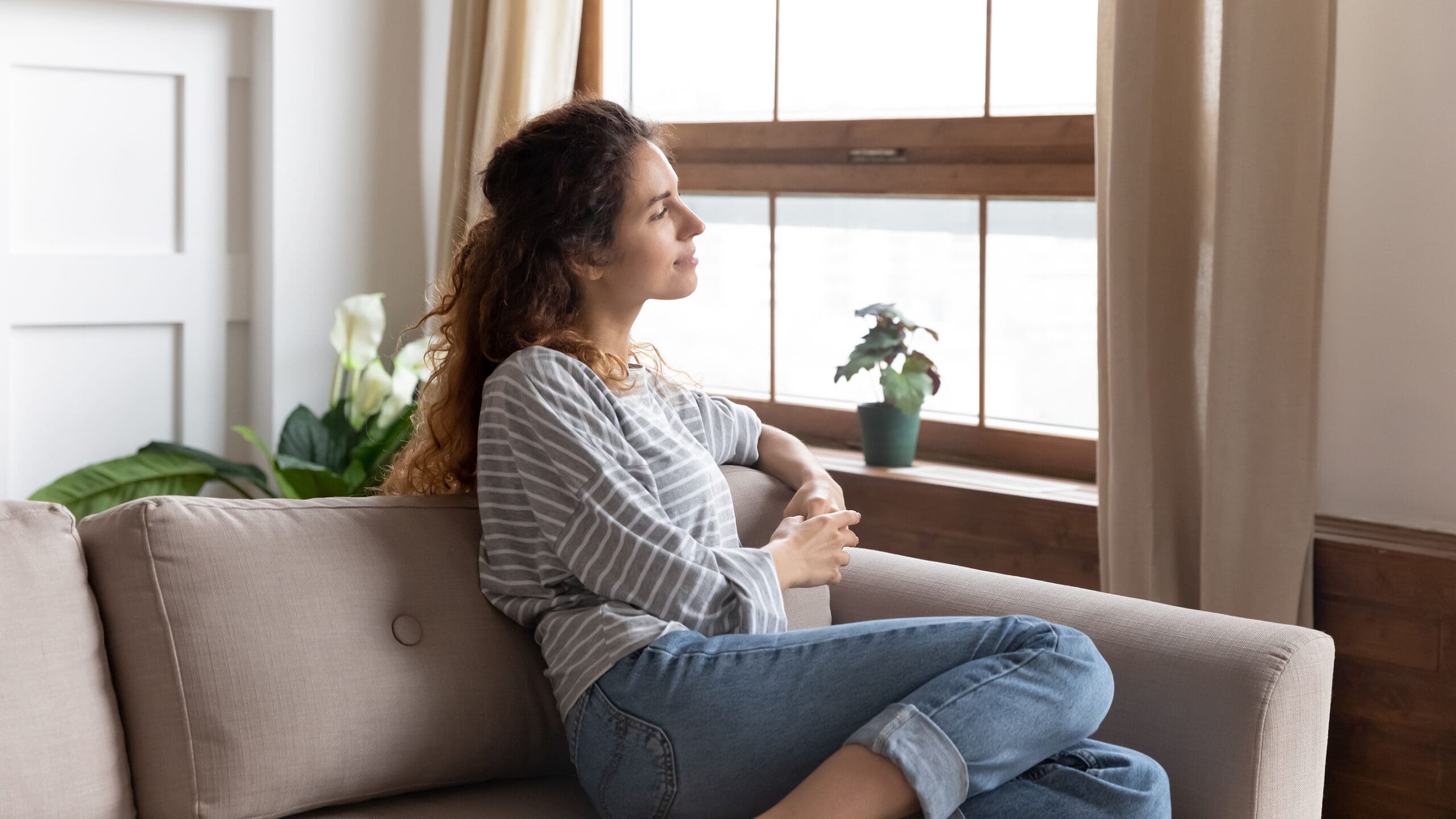 A woman with a pill and a glass of water in hand